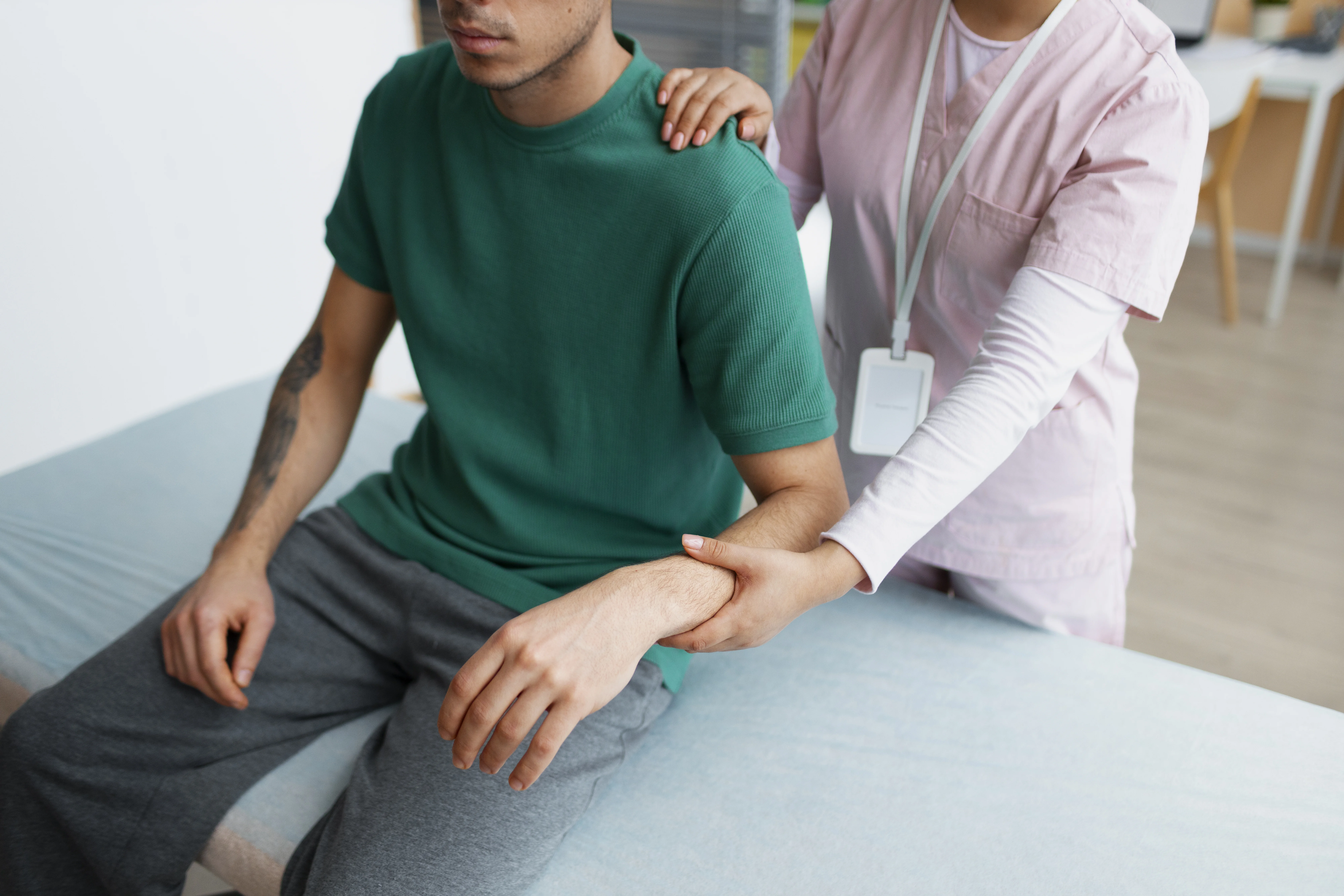 An man getting physiotherapy for his arm from an female therapist