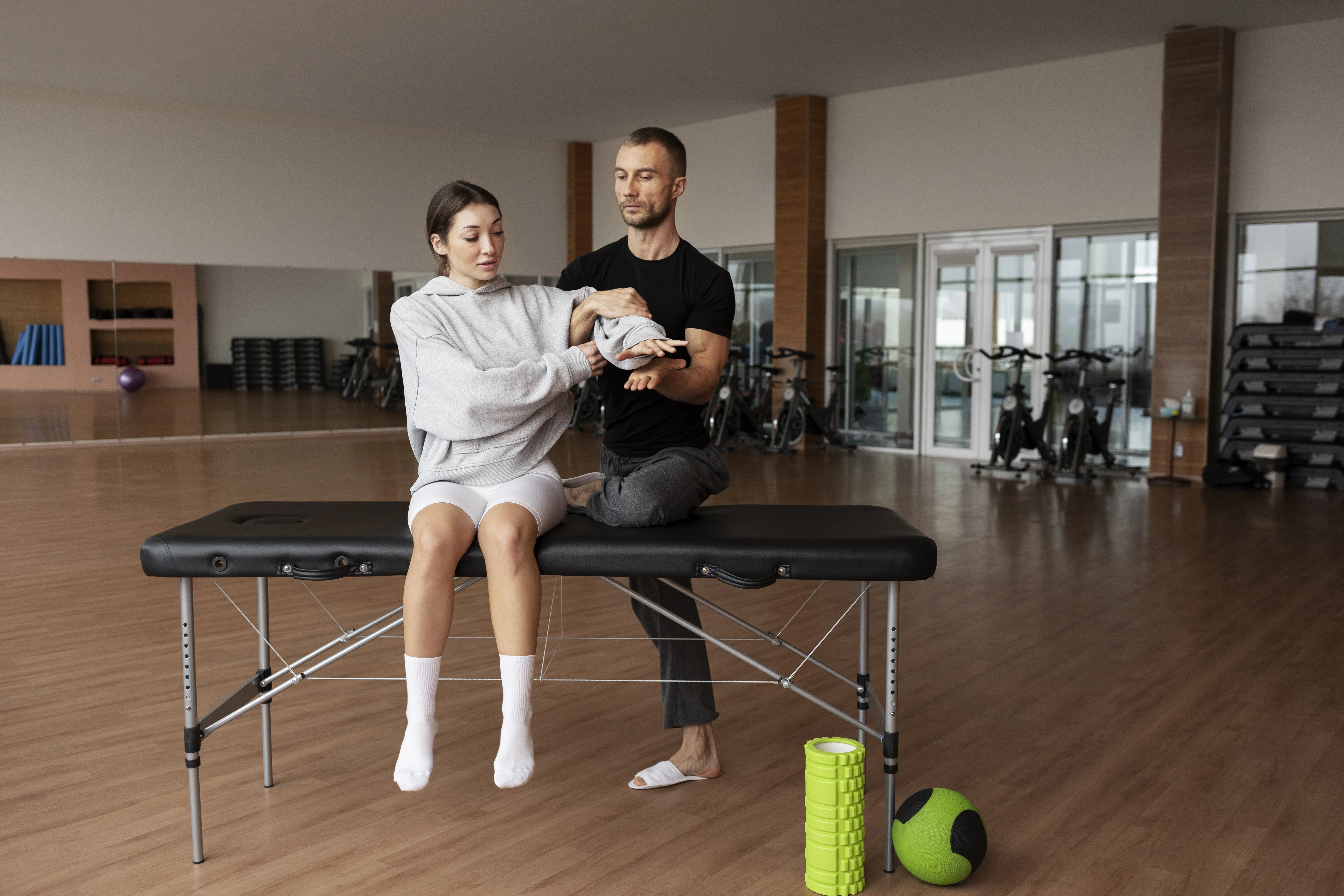 patient-doing-physical-rehabilitation-helped-by-therapists